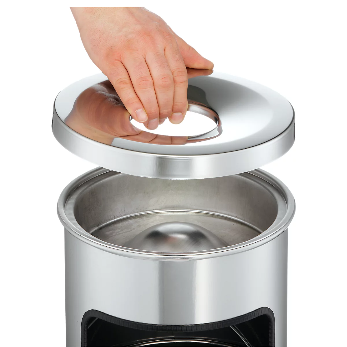 A hand lifts the lid of a stainless steel trash can.