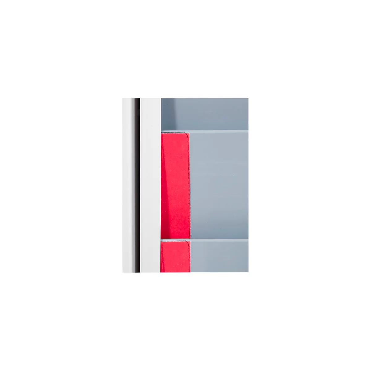 Close-up of a white wall with gray levels and a red element.