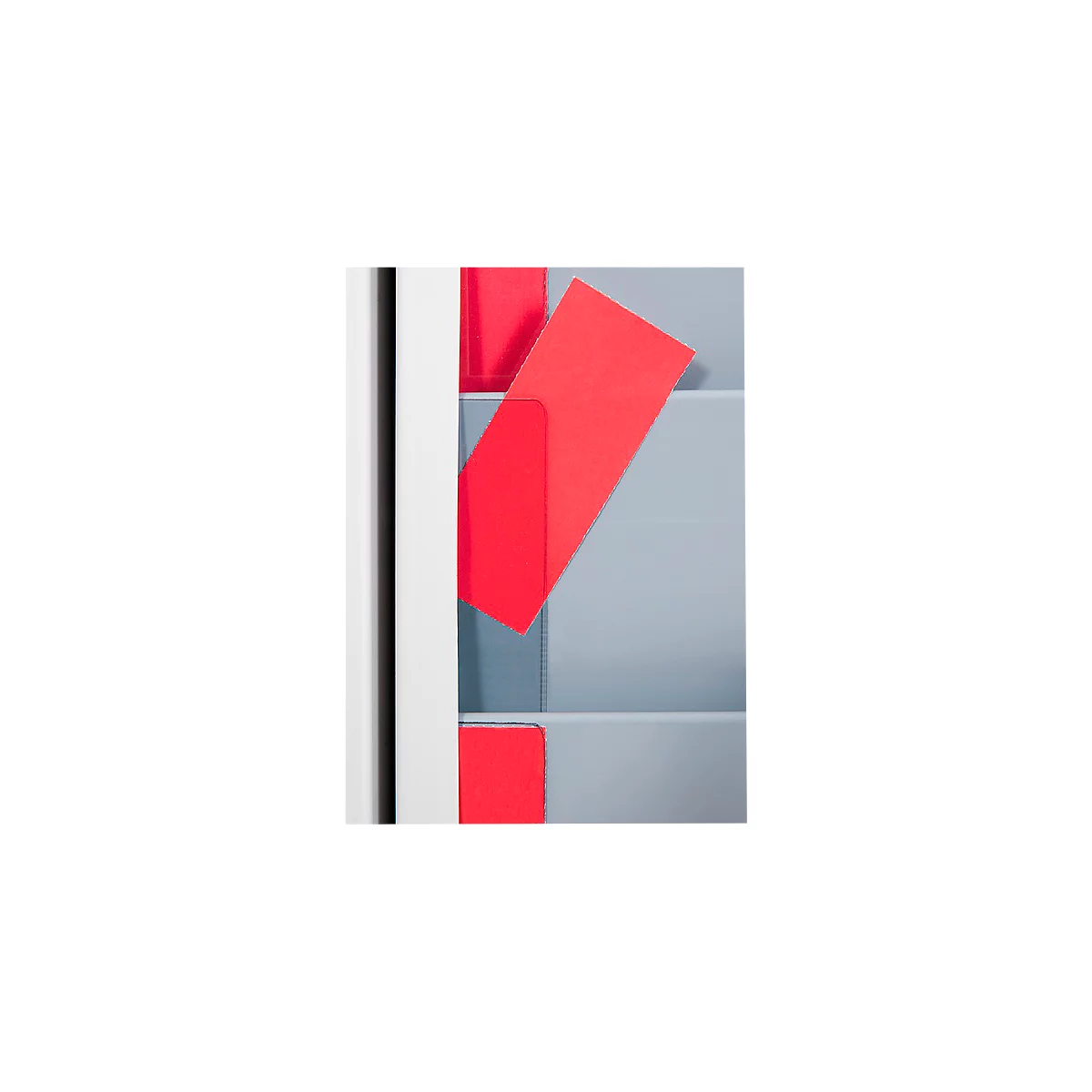 Overhead view of a storage system with red cards. One card lies diagonally in a compartment.