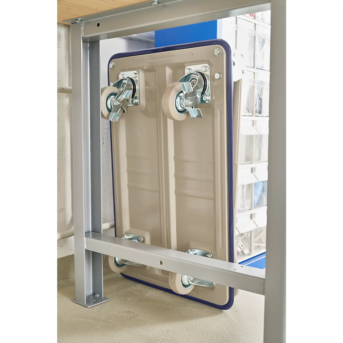 A beige trolley attached to a metal structure. The detail shows the wheels.