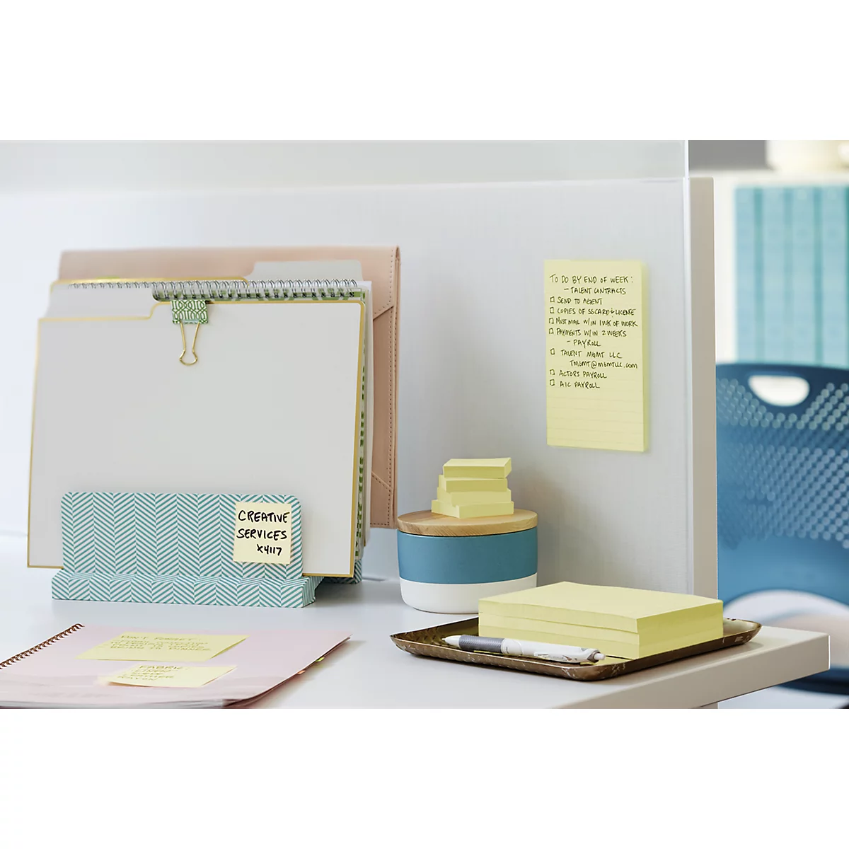 Office scene with notes, folders, and pens. A yellow sticky note contains a handwritten to-do list.