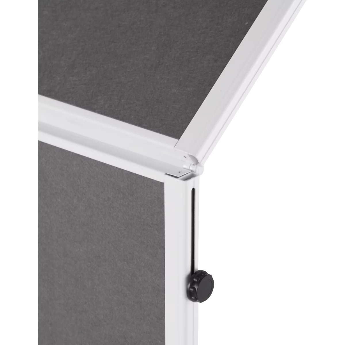 Close-up of a white, rectangular object with a gray surface and black knob.