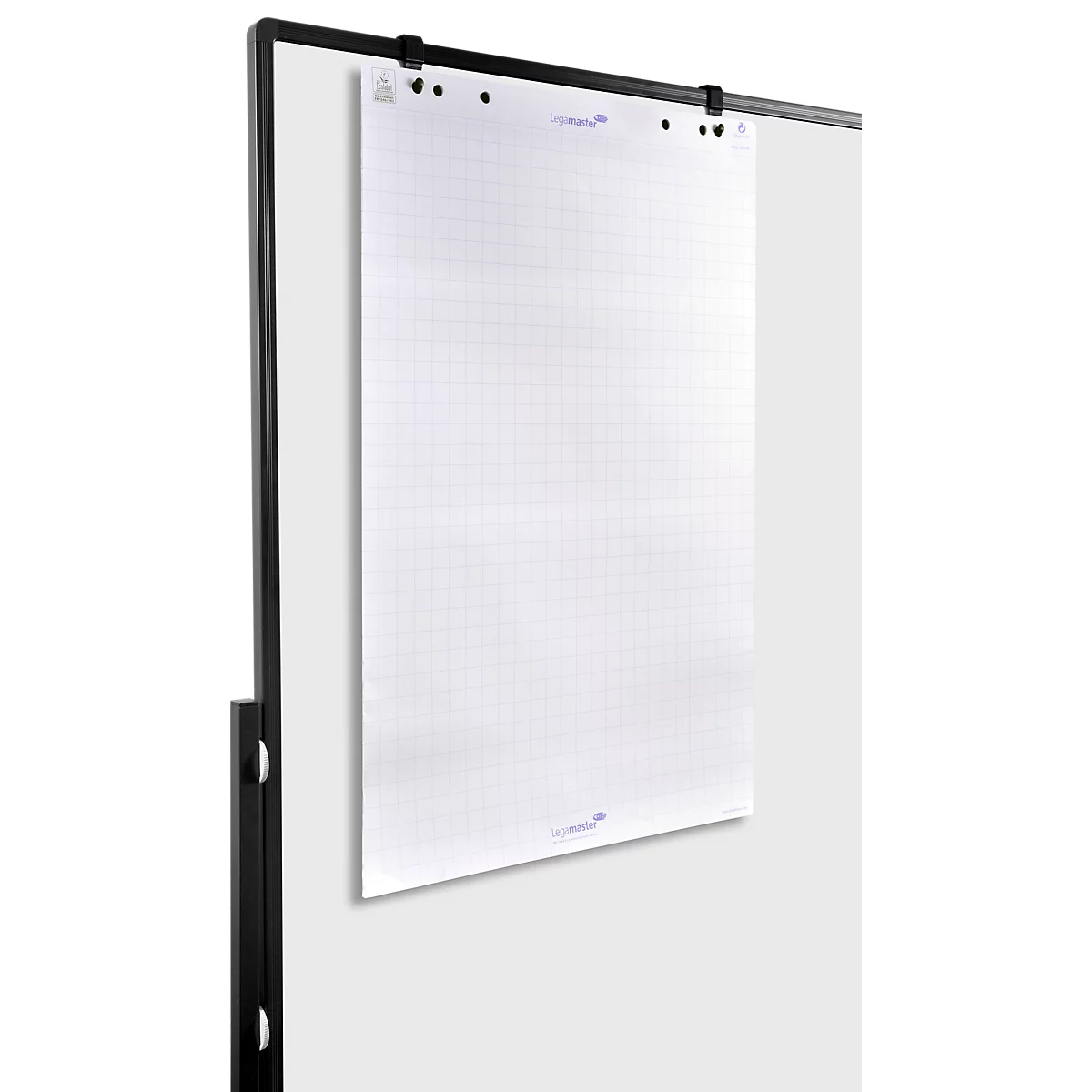 A white, grid-lined flip chart paper is attached to a black metal holder, hanging against a gray wall.
