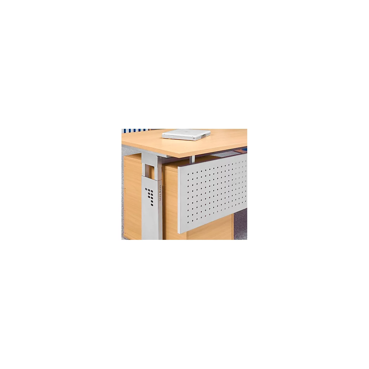 A desk with a wooden top and silver metal legs. There's a laptop on the top. On the front of the desk, there is a perforated metal plate.