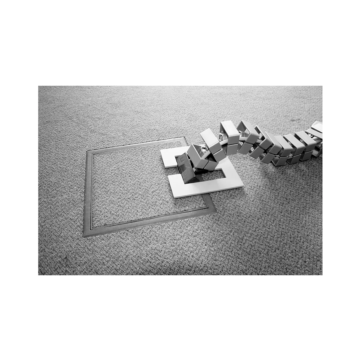 Domino effect with cubes impacting a square cut-out in the flooring.