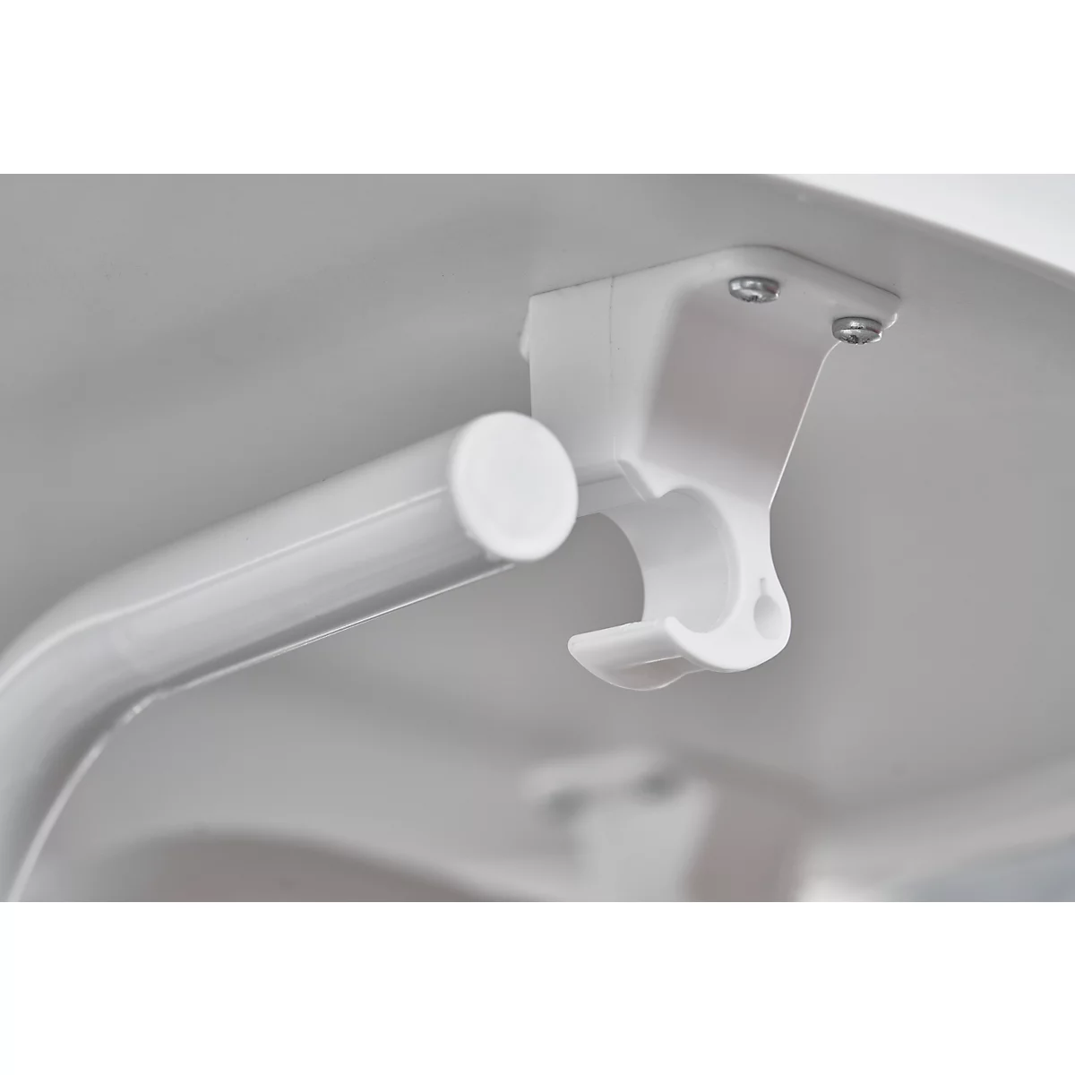 Close-up of white support system: tube, support, screws.