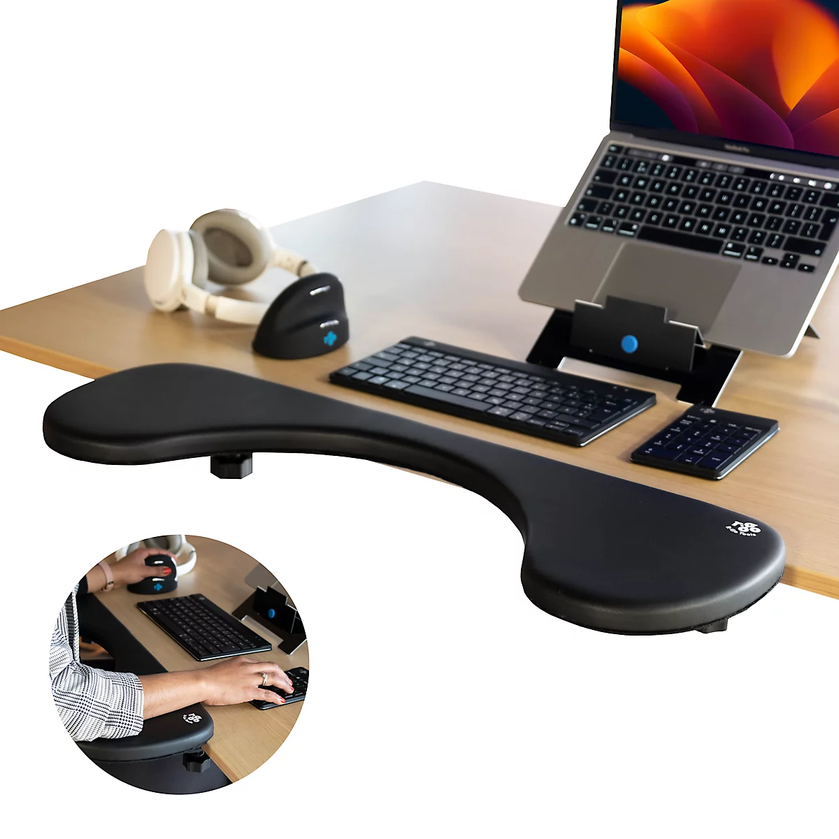 Black armrest with mouse, keyboard, and laptop on wooden desk. Small round image shows usage.