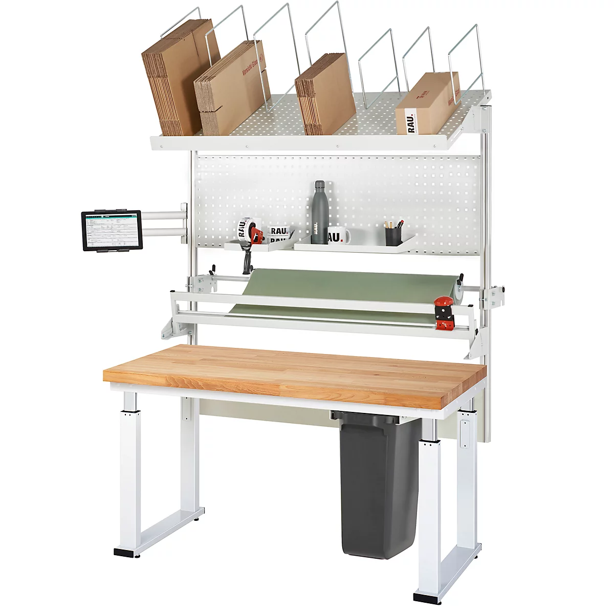 Inpakstation met tafel, papieren rol, pakketplanken en dozen. Een tablet is links bevestigd.
