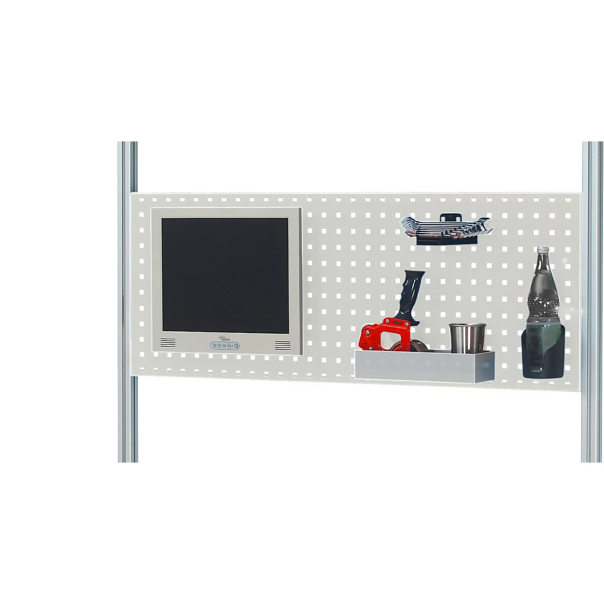 Graue Lochwand mit Monitor, Werkzeugen und Flasche. Verschiedene Gegenstände hängen oder stehen vor der Wand.