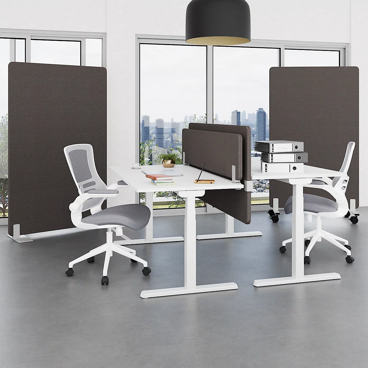 Office space with desks, chairs and partition walls. Large windows with a view of the city.