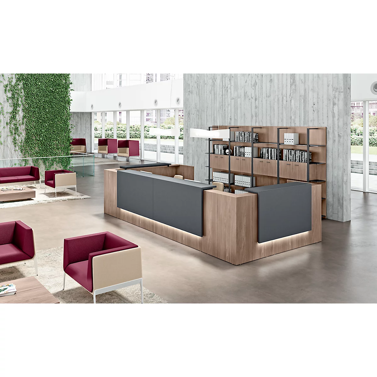 Modern reception desk with wood and grey tones, shelves behind and comfortable seating.