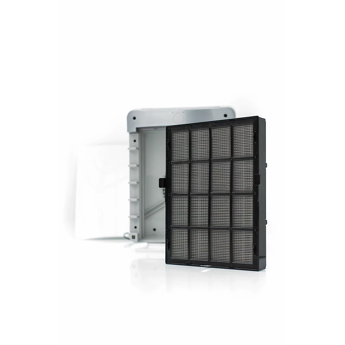 Opened filter housing with filter element. Gray base plate with a removable black filter.