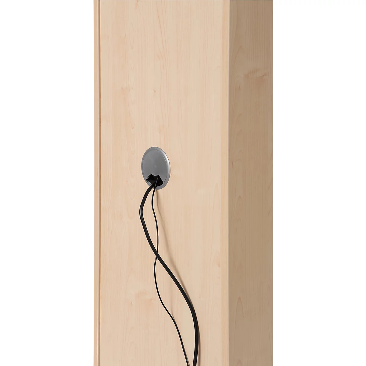 Close-up of light wood surface with a gray cable grommet from which black cables protrude.