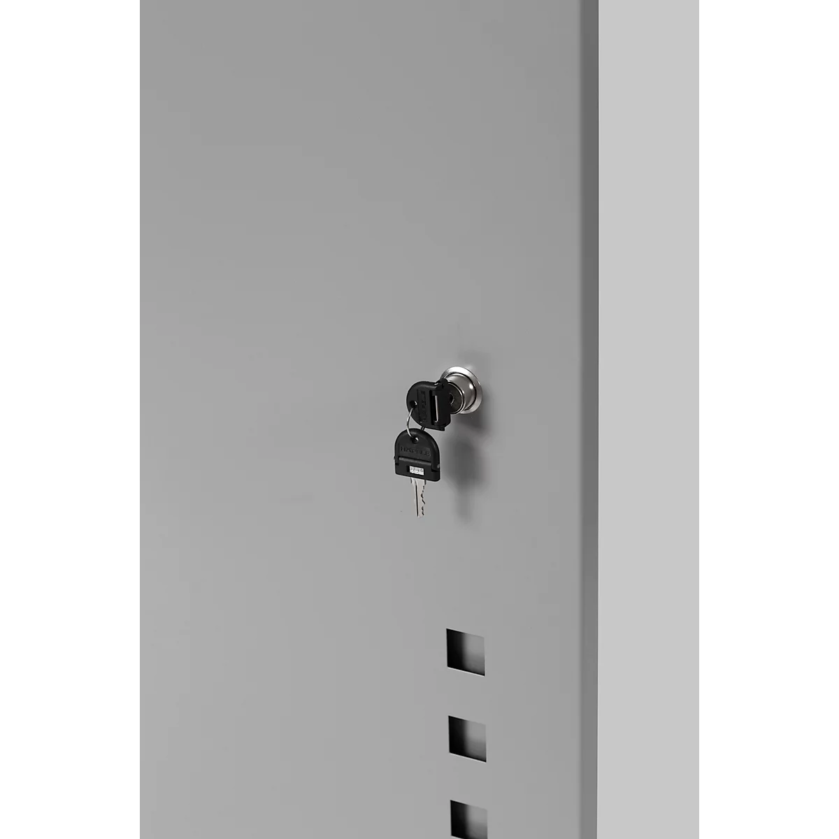 Gray metal door with keyhole and two keys. Three square recesses are visible below.