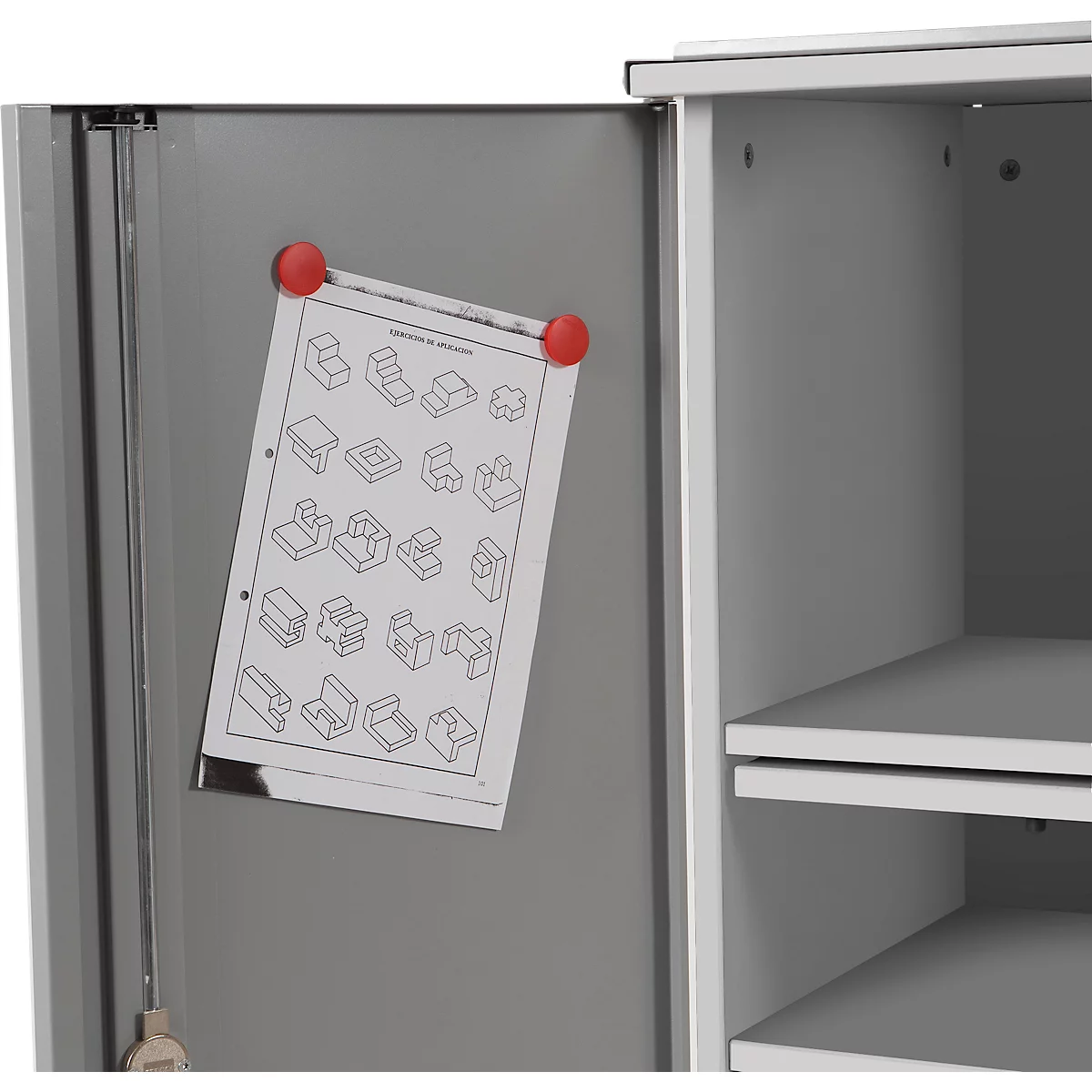 Grey cabinet door with a drawing attached with red magnets. Inside, a cabinet compartment with shelves can be seen.