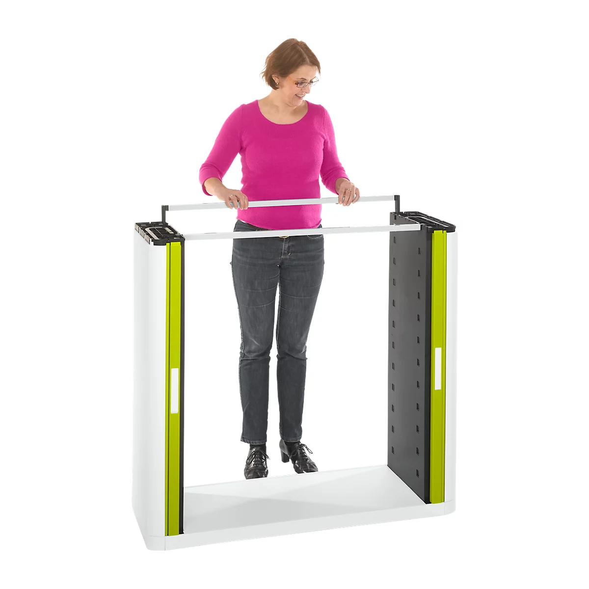 Woman in pink shirt stands at a white trade show stand with green and black accents and holding bars.