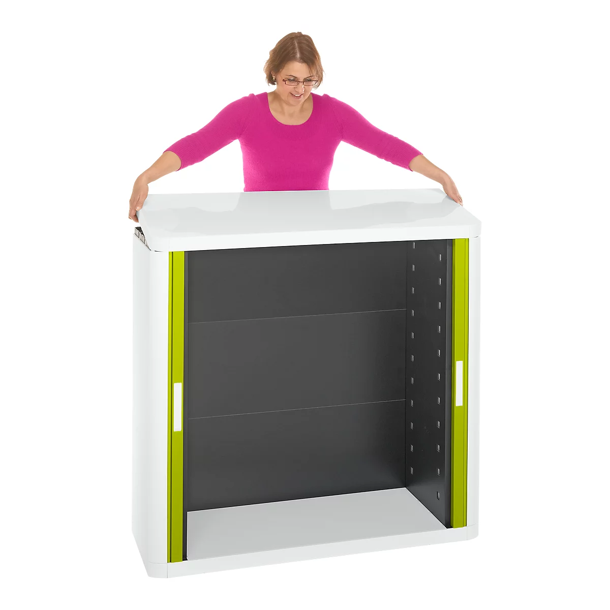 Woman with glasses opening a white cabinet with greenish elements.