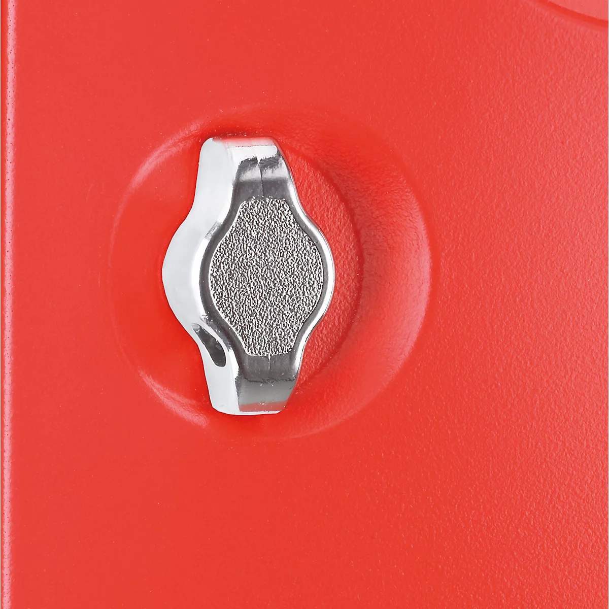 Close-up of a red plastic part with a silver, triangular turning knob.