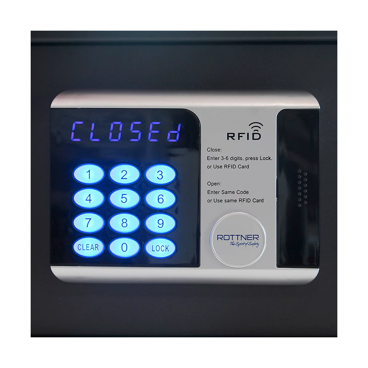 Close-up of a safe with a digital control panel. The display reads "CLOSED". Below are illuminated buttons and an RFID reader.