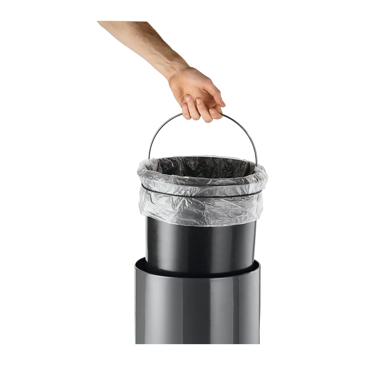 A hand holding a trash can with a black bucket and plastic bag by a metal handle.