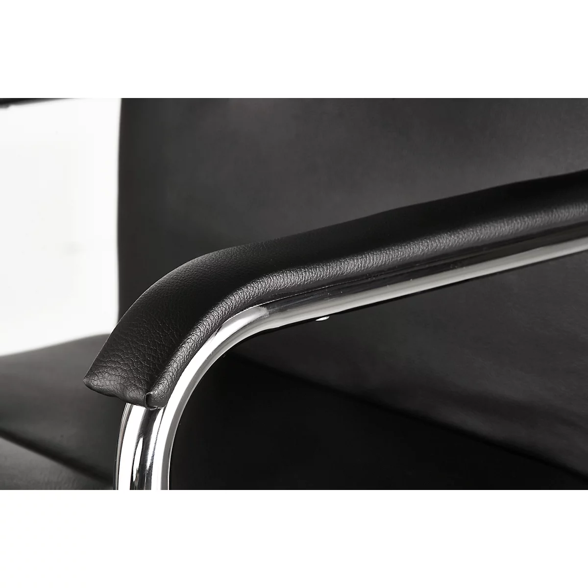 Close-up of a black leather armrest with a chrome metal frame.