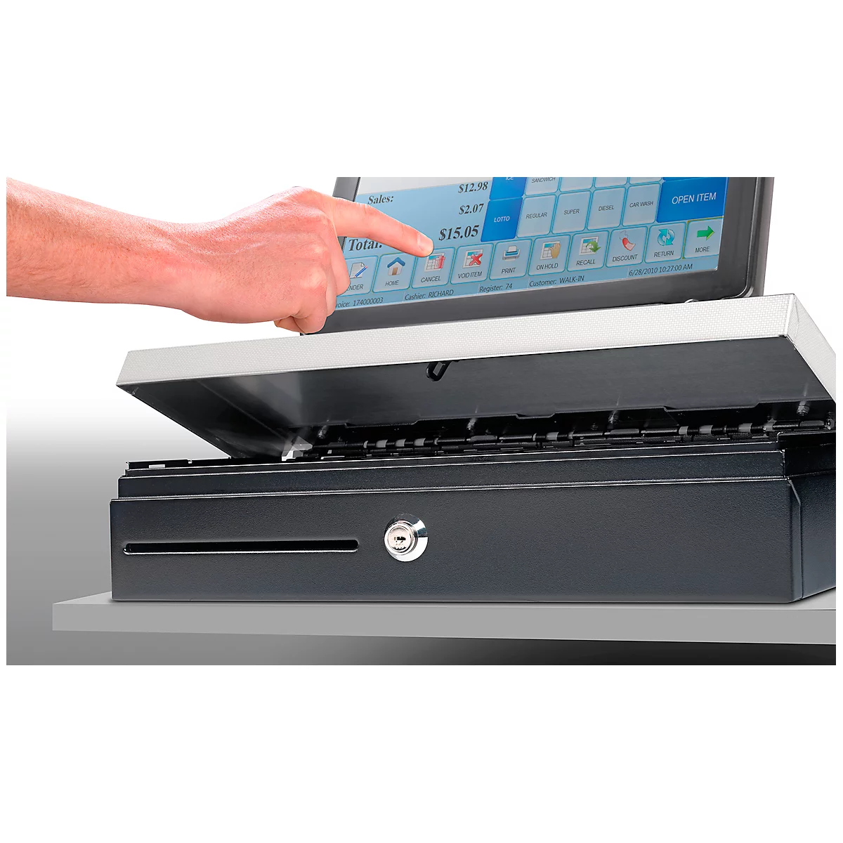 A hand touches the screen of a cash register. The screen displays numbers and symbols. Below is a drawer.