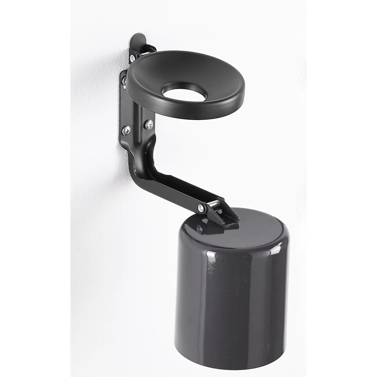 Black wall-mounted holder with cup and cover, attached to a white wall.