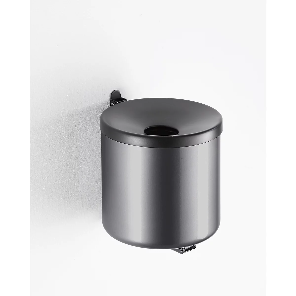 Gray, wall-mounted trash can. The lid has a hole, below is a black ring. On a white background.