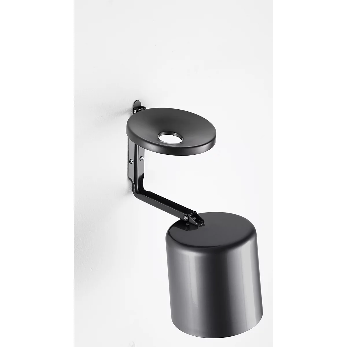 Black wall lamp with a round lampshade and a cylindrical housing, mounted on a white wall.