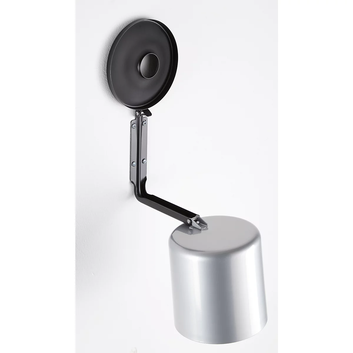 Metal container on wall, silver cylinder with black lid and arm.