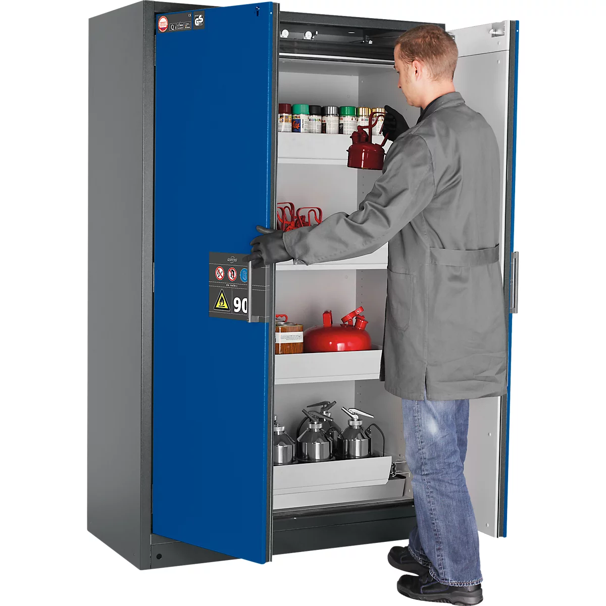 A man opens a blue safety cabinet. The cabinet contains several containers and a red gas cylinder.