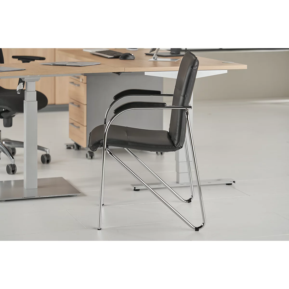 Black leather chair with chrome legs in an office.