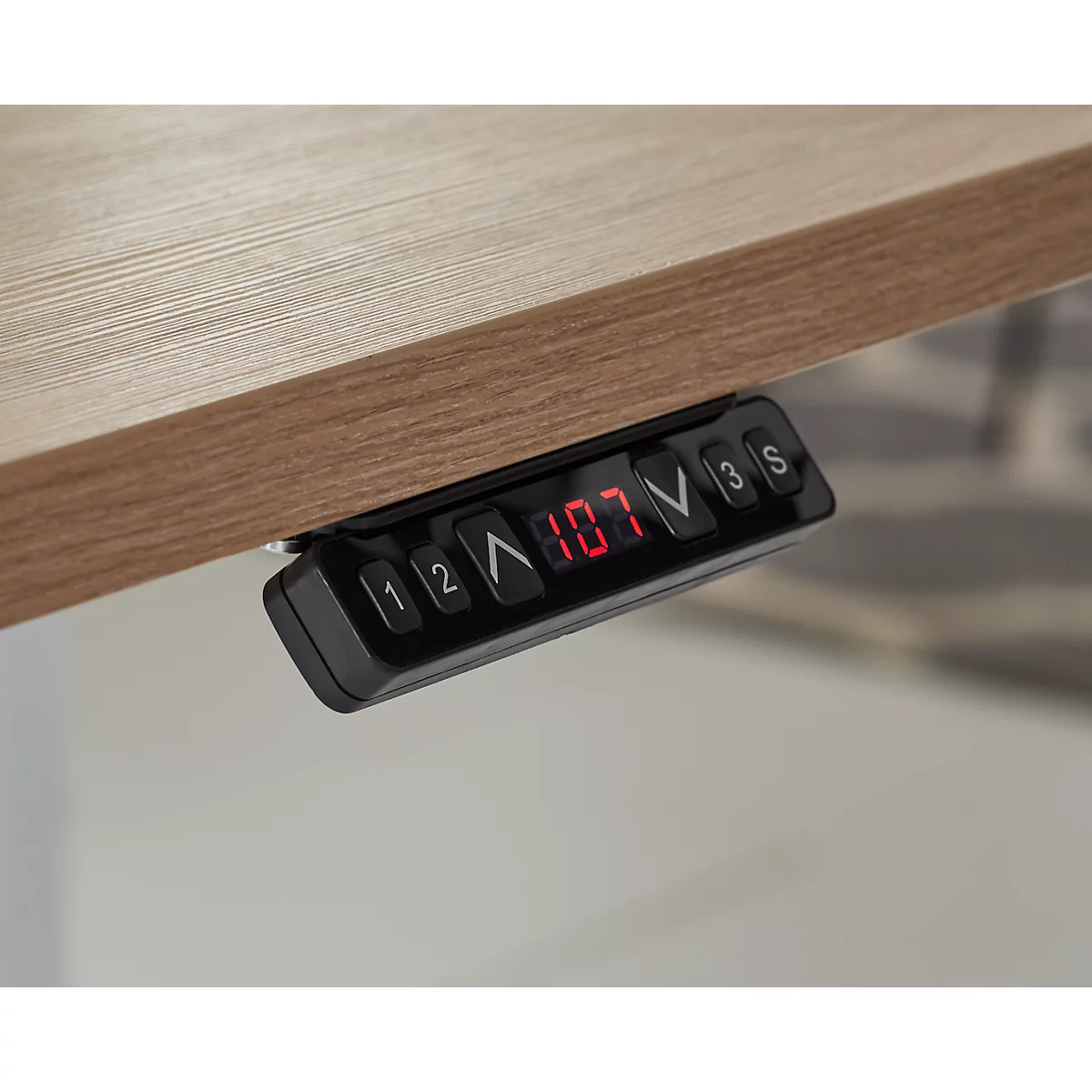 Close-up of the control panel of a height-adjustable desk, with a red digital display indicating the height in cm.
