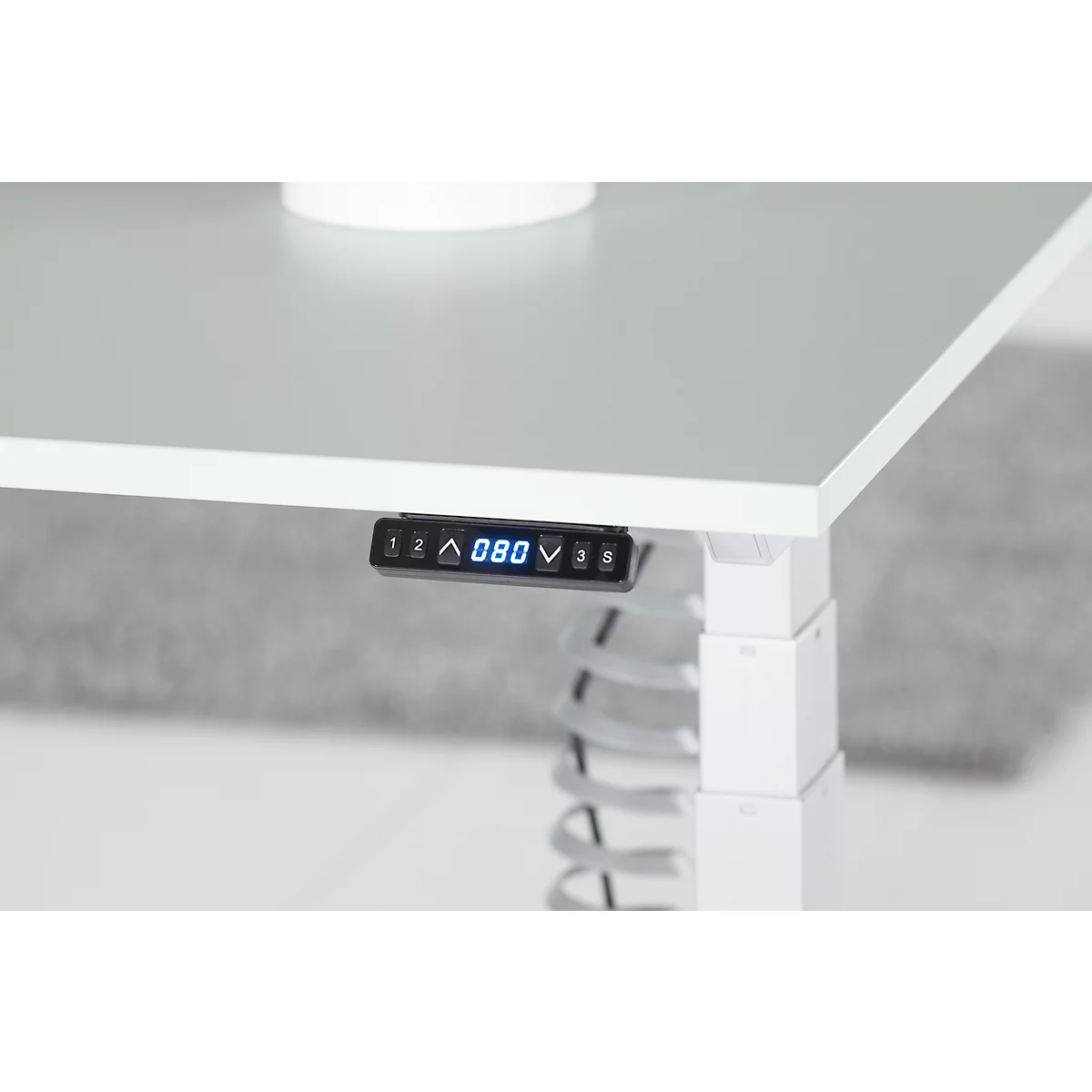 Close-up of a white desk with a black control panel showing the height in blue digits: 080.