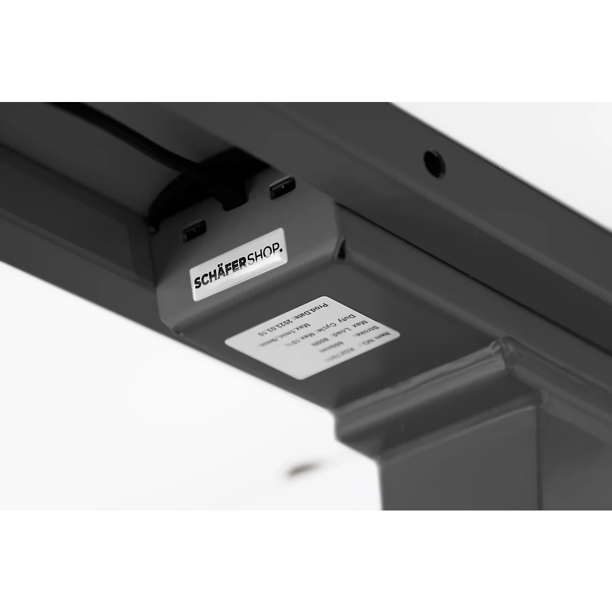 Detail shot: Underside of a desk with USB ports and the Schäfer Shop logo.
