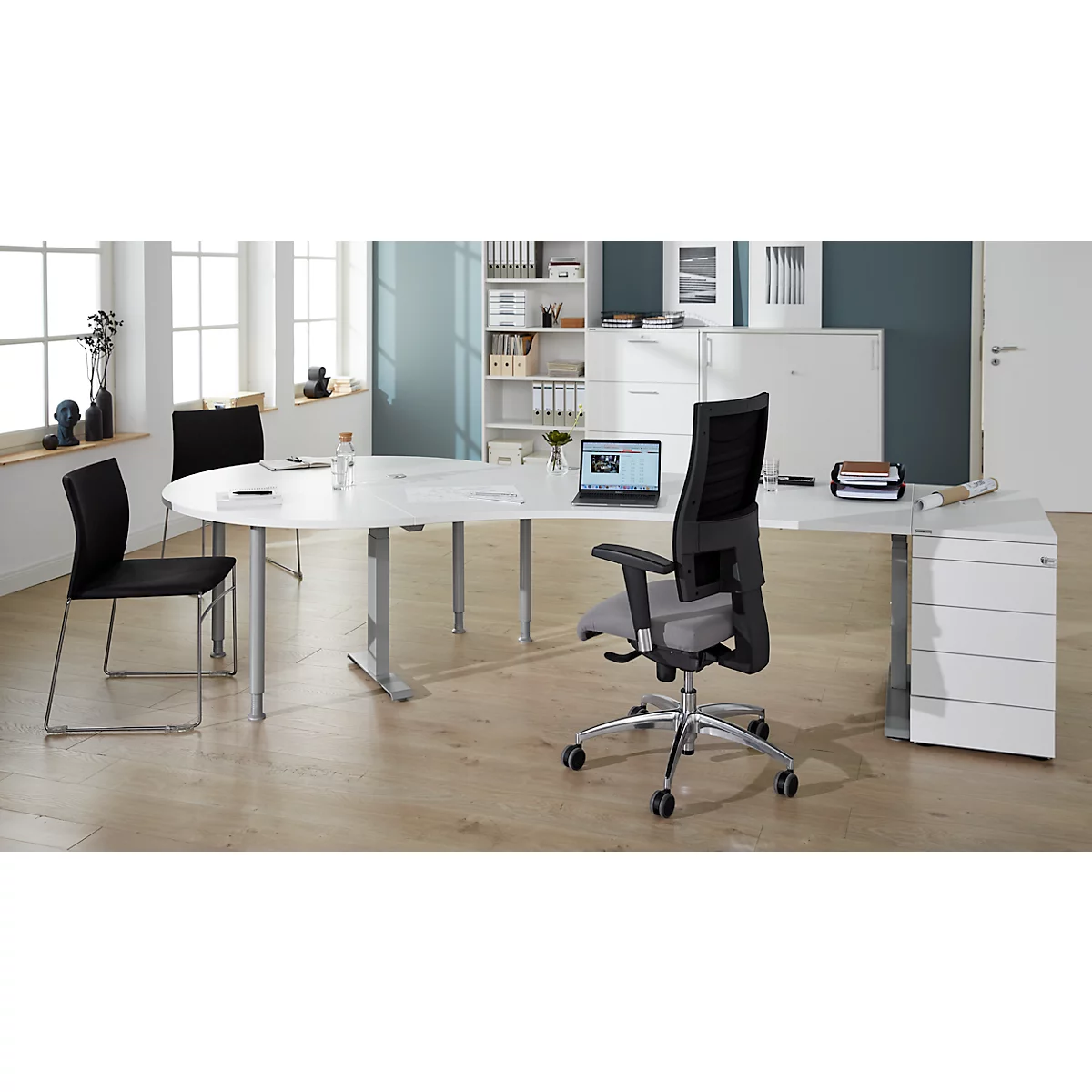Office with white desk, chairs, swivel chair, laptop and filing cabinet.