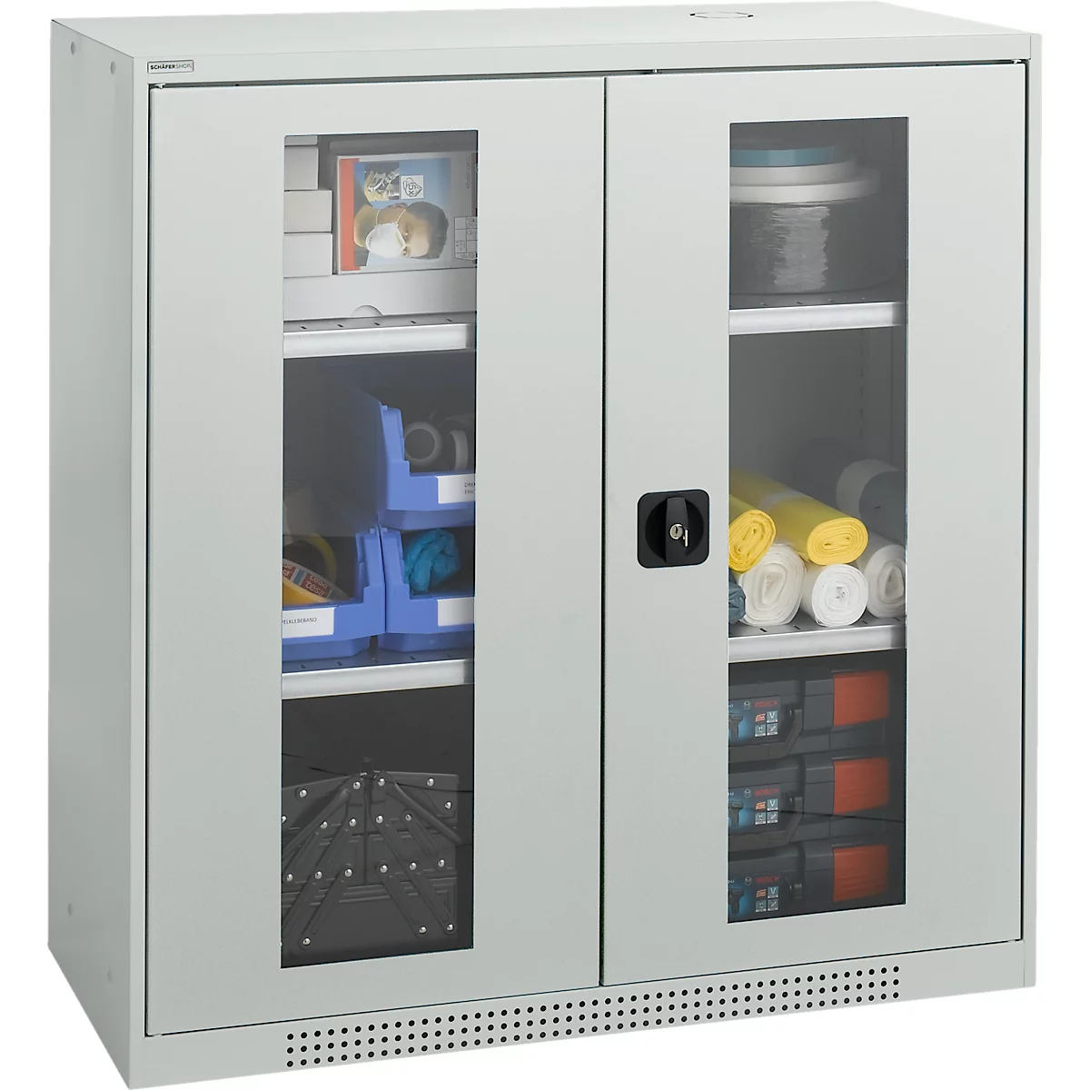 Gray cabinet with glass panes. Inside, shelves with office supplies, paper rolls and boxes.