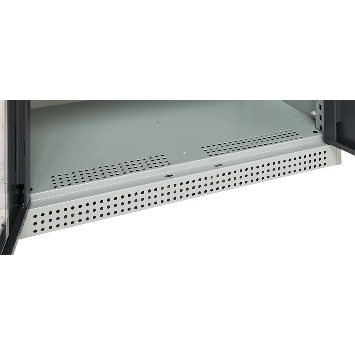 Close-up of a cabinet interior, gray metal plate with rows of holes.