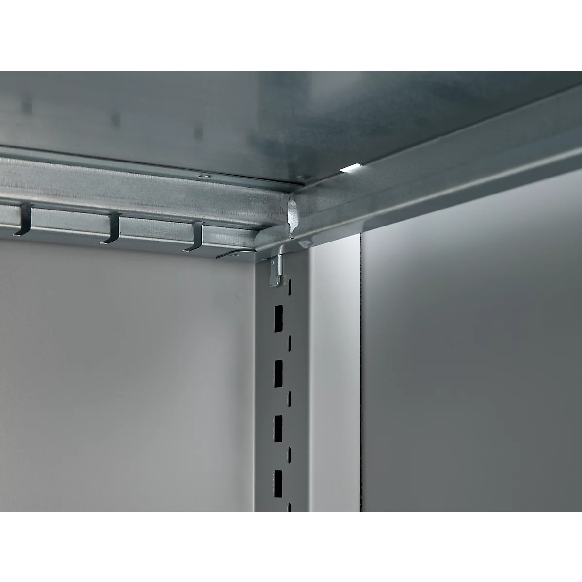 Corner of a metal shelf, gray background, detail shot of the construction.