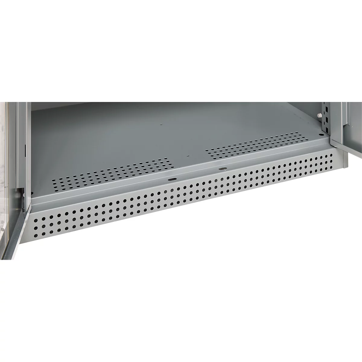 Close-up of a gray metal shelf in a cabinet, perforated with small holes.