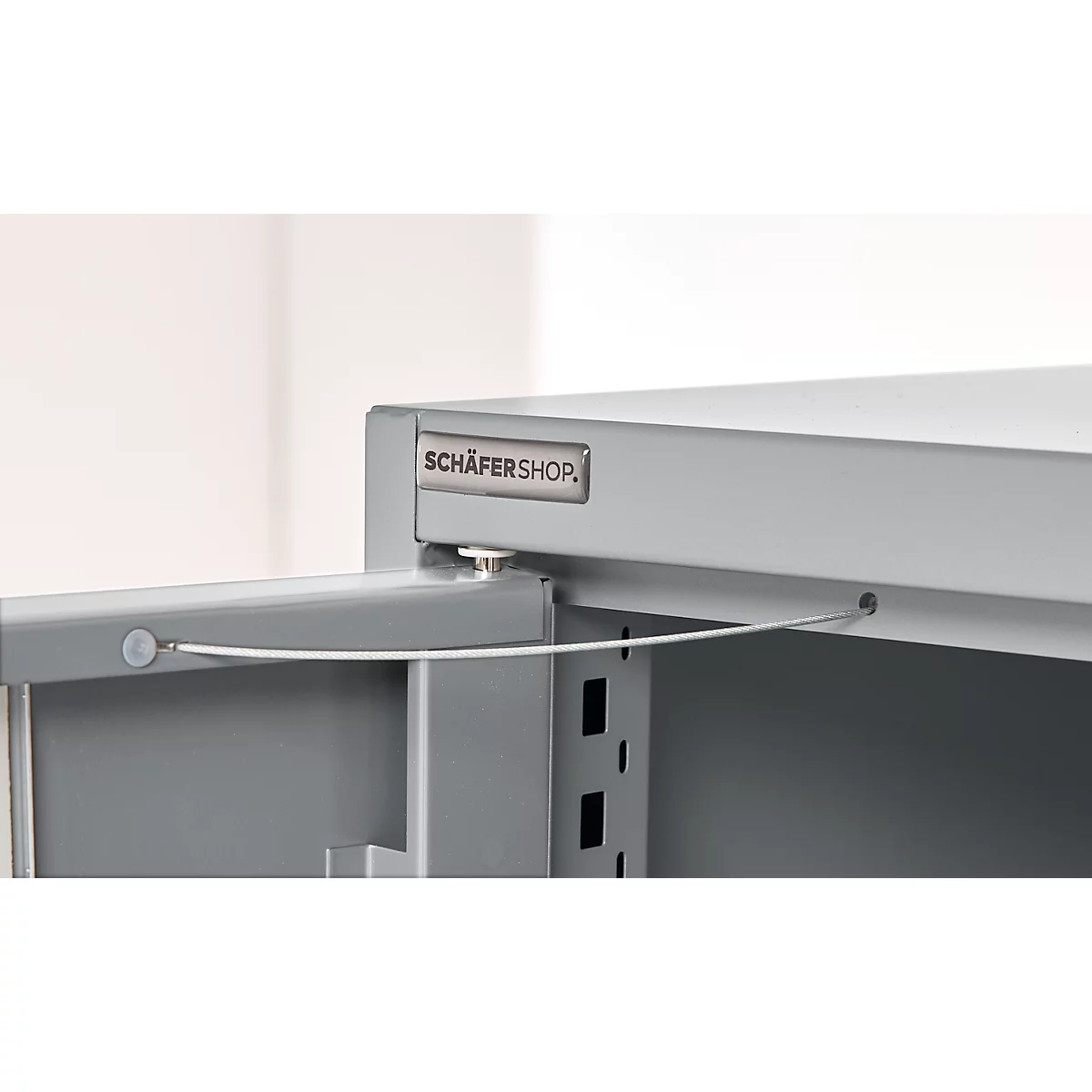 Detail of a gray cabinet with an open compartment. The "SCHÄFERSHOP" logo is visible at the top.
