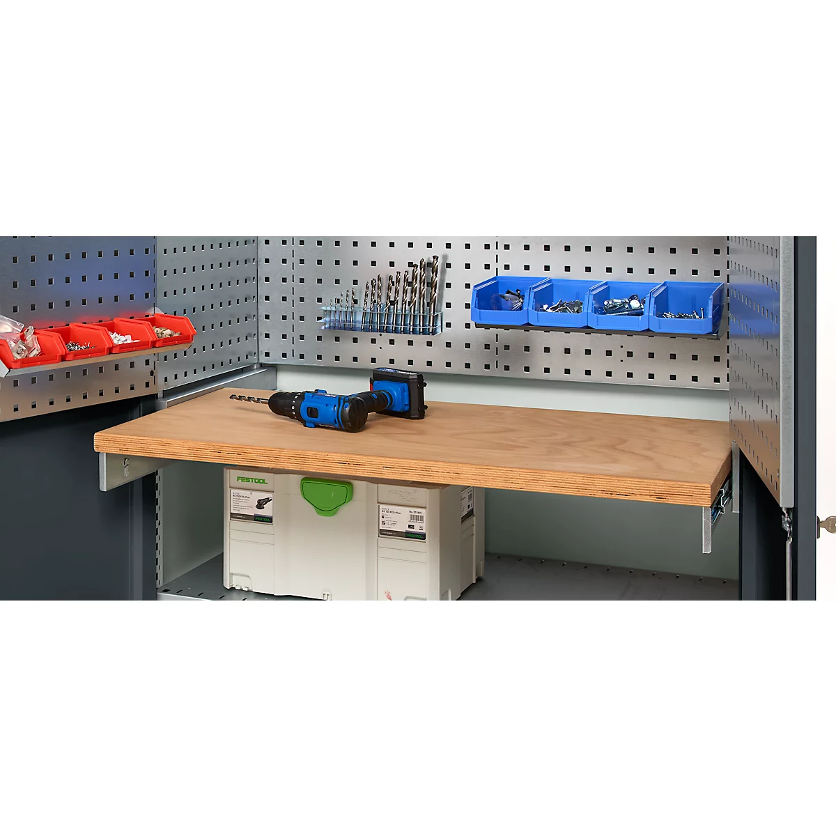 Workbench with pegboard, blue cordless screwdriver, drill bits, and storage bins.