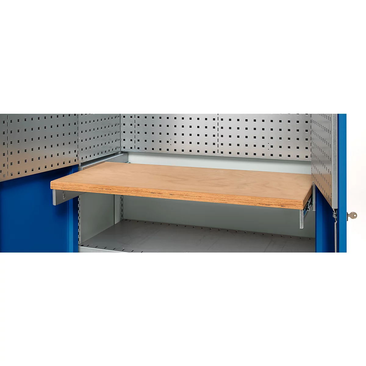 Close-up of a workbench with wooden top. Blue side walls, gray pegboard walls, and metal supports.