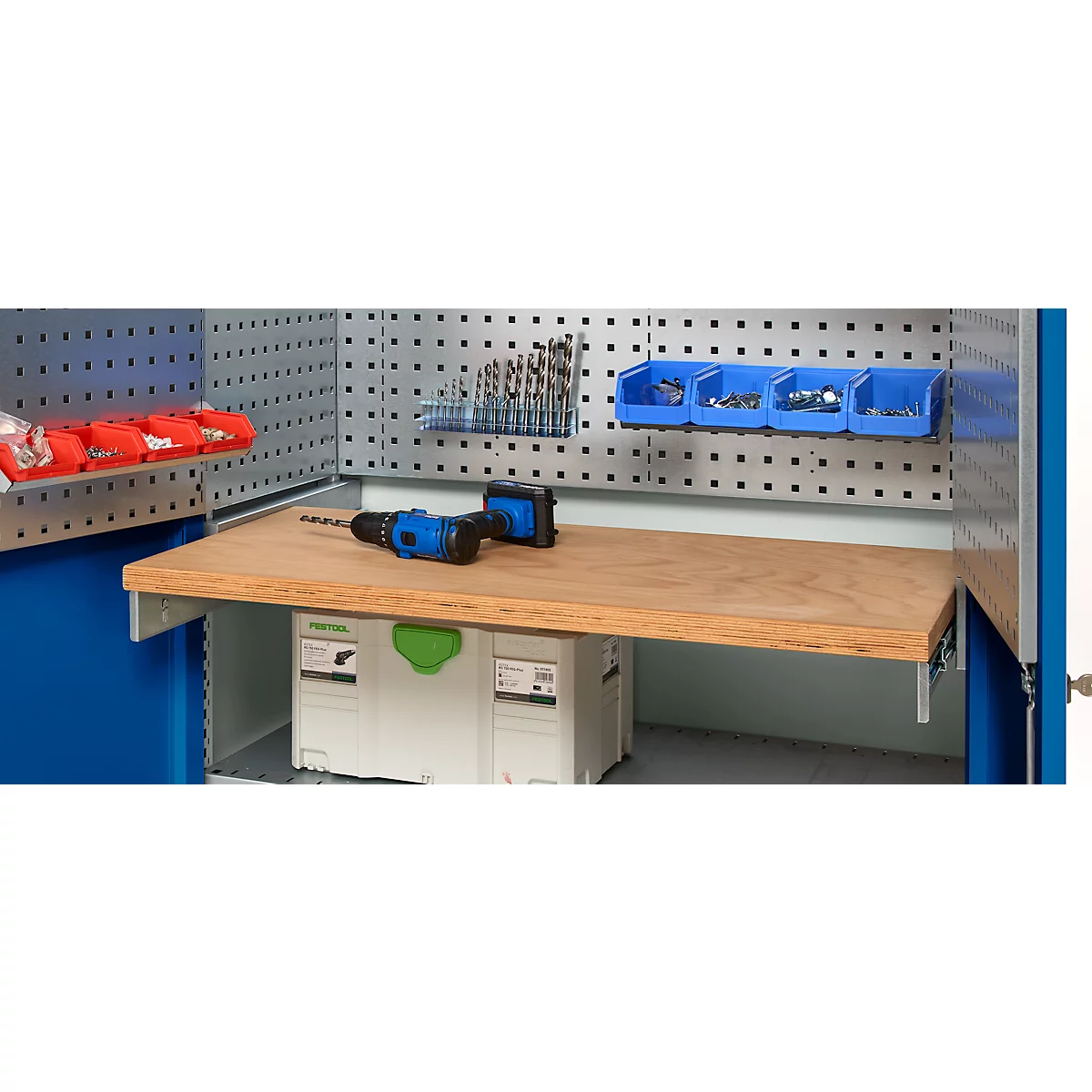 Workbench with drill, drill bits, and storage boxes.