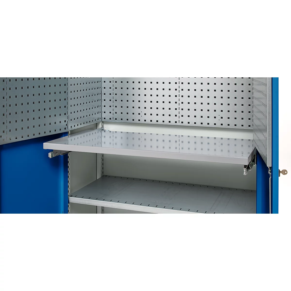 Interior view of a blue tool cabinet with perforated walls and shelves.