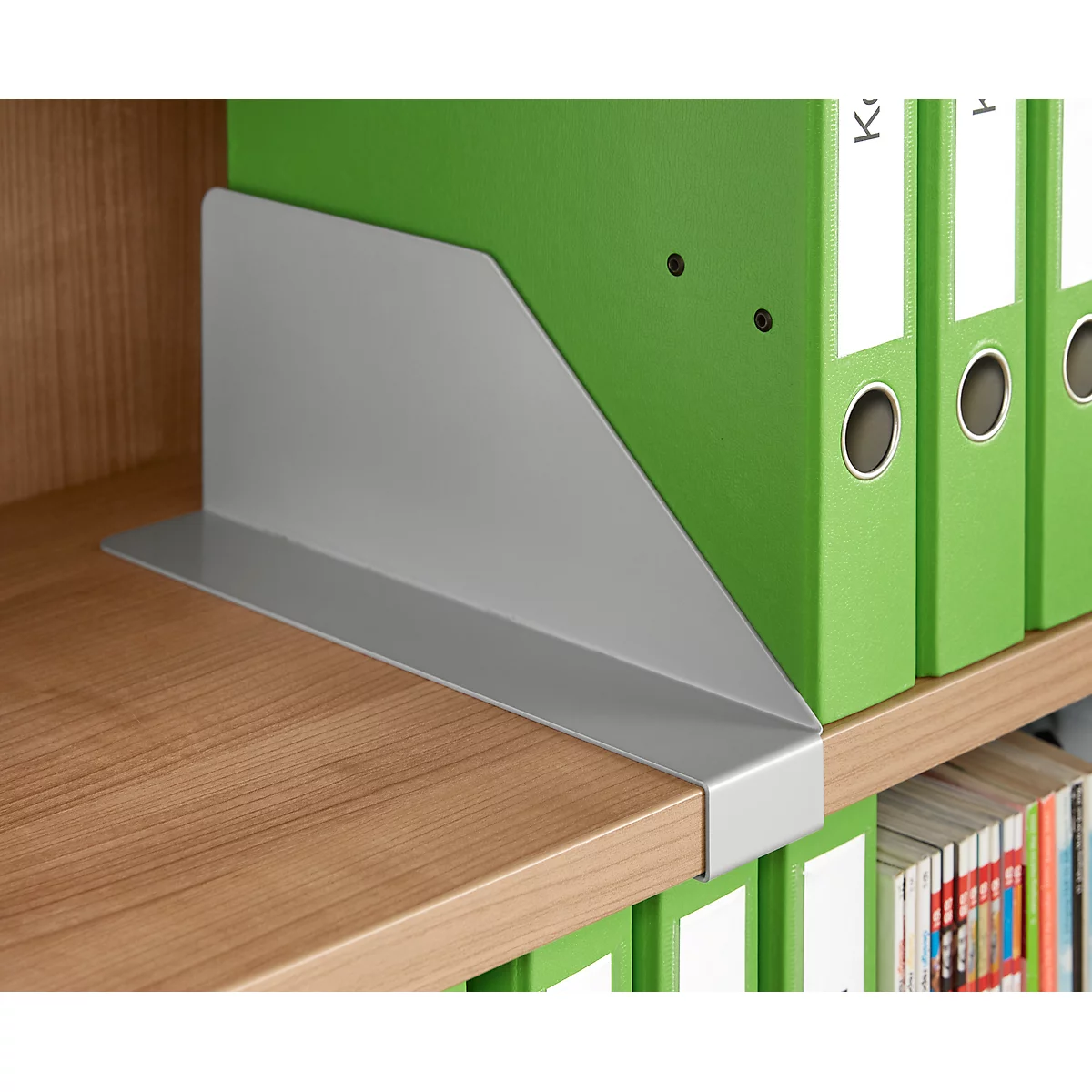 Gray bookend on wooden shelf, next to green file folders.