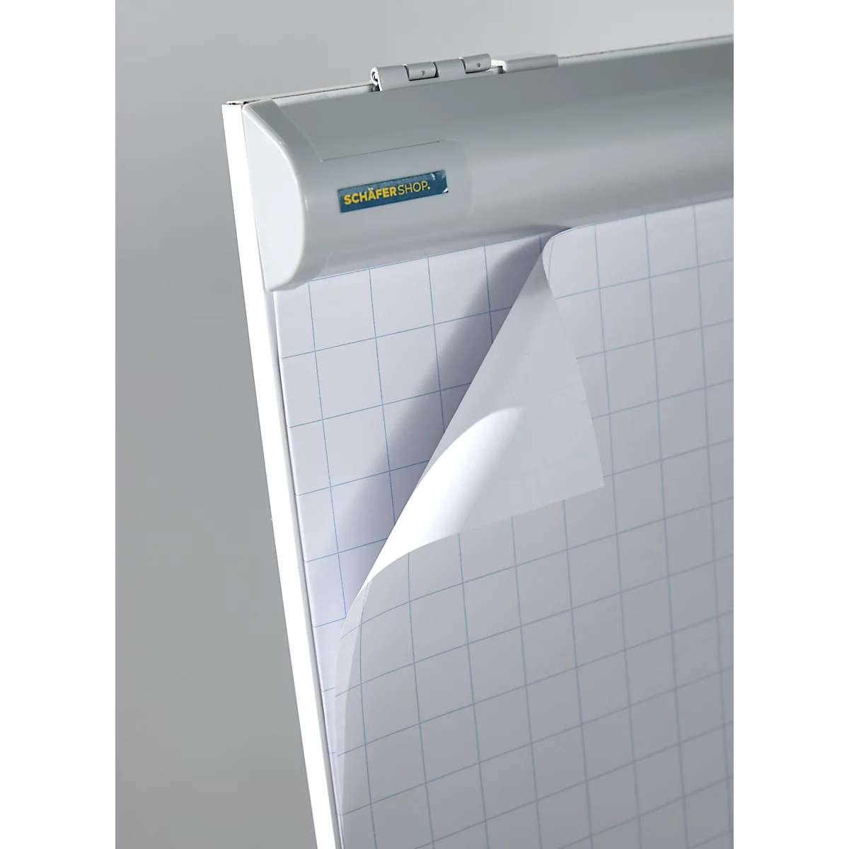 Detailed view of a flipchart with squared paper, partially turned over. The top shows a SCHÄFER SHOP logo.