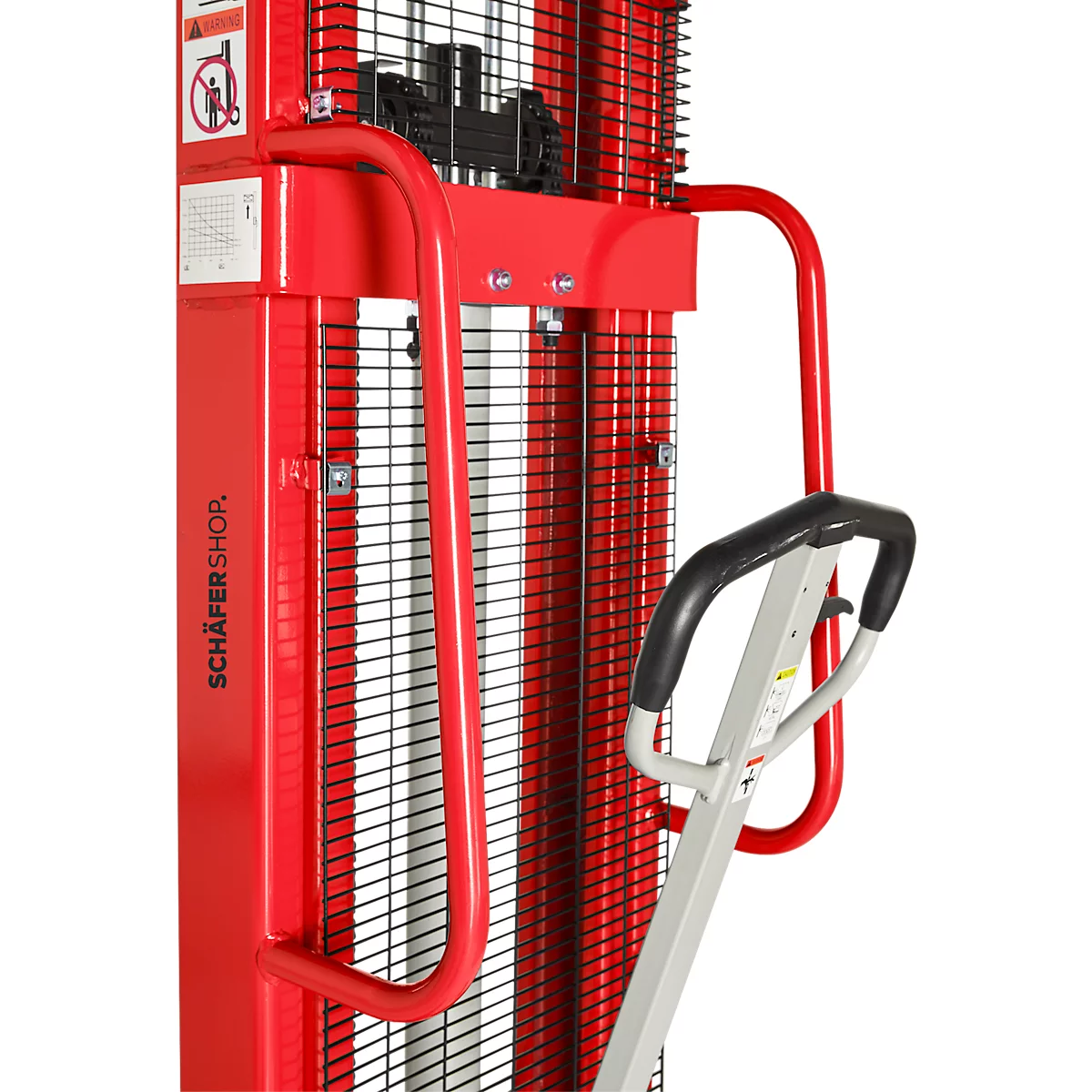 Close-up of a red lifting device. Visible are a bracket, a handle, and a grid. The handle is black and silver.