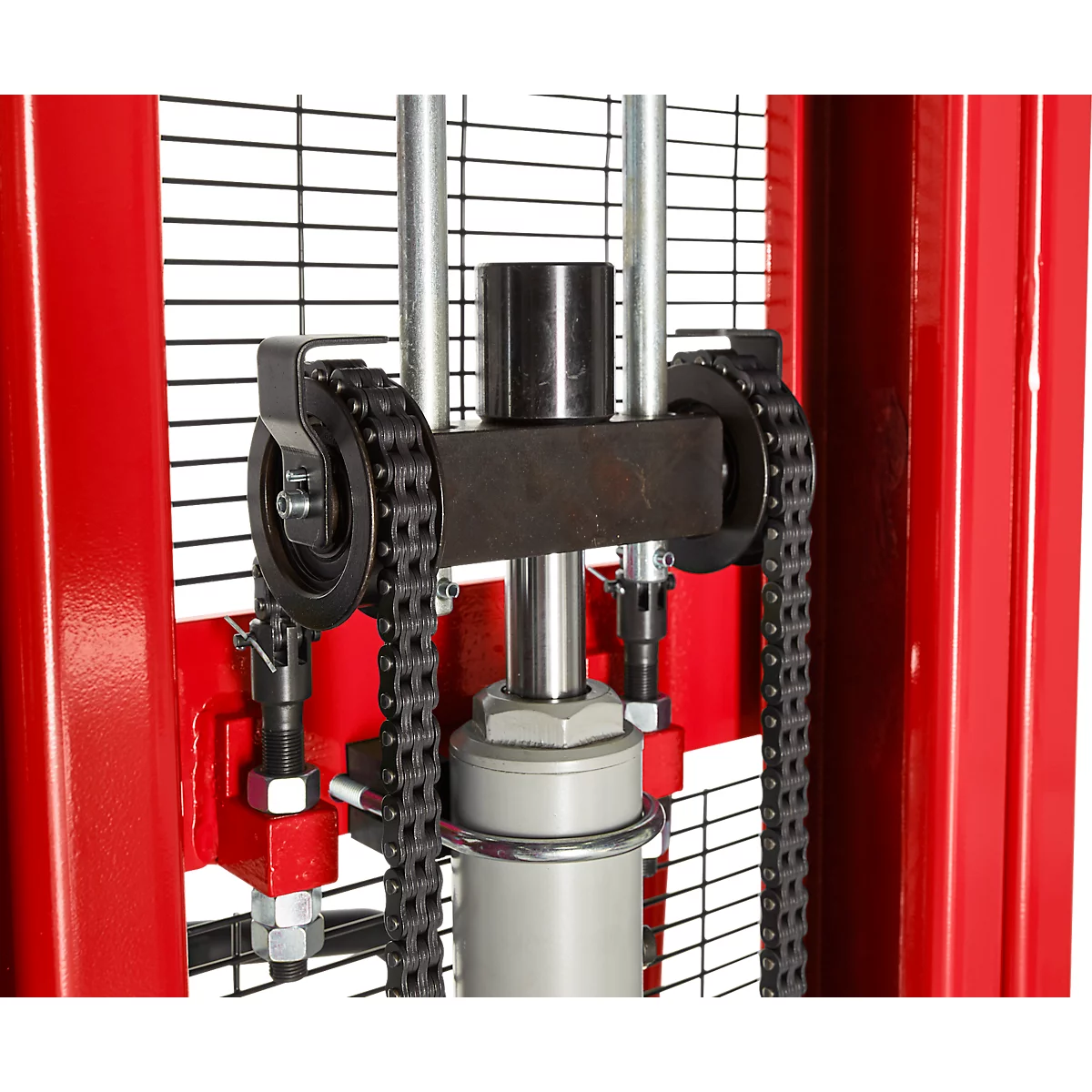 Close-up of a red lifting device featuring a sprocket and chain for lifting work.