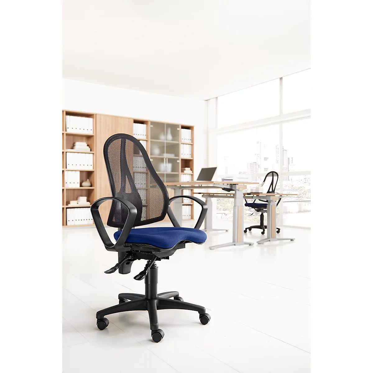 Office chair with mesh back and blue seat. Other chairs and desks in the background.